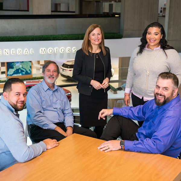Group of GM employees smiling.