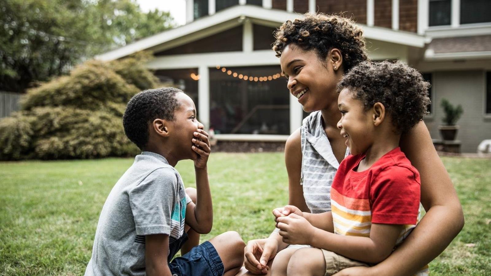 A mother and two children spend quality time together in their backyard after work