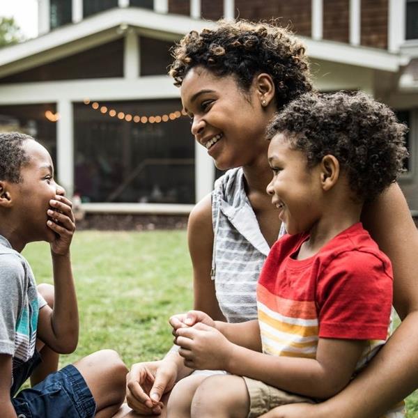 A mother and two children spend quality time together in their backyard after work