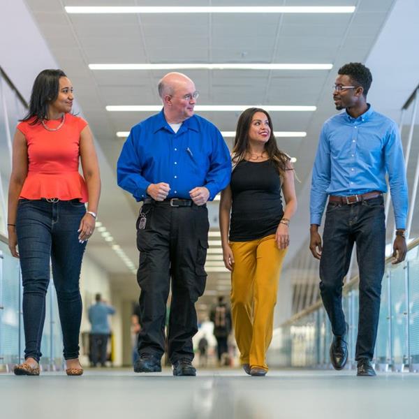 Diverse group of employees walking through the office
