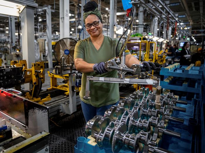 Woman in glasses working on manufacturing line