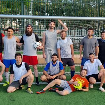 Males standing in front of soccer goal
