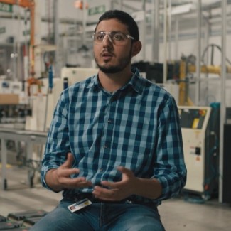 Man with safety glasses sitting and talking