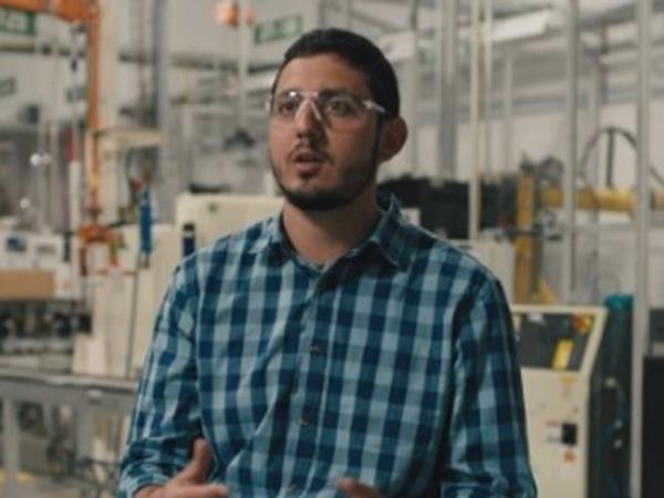 Man with safety glasses sitting and talking